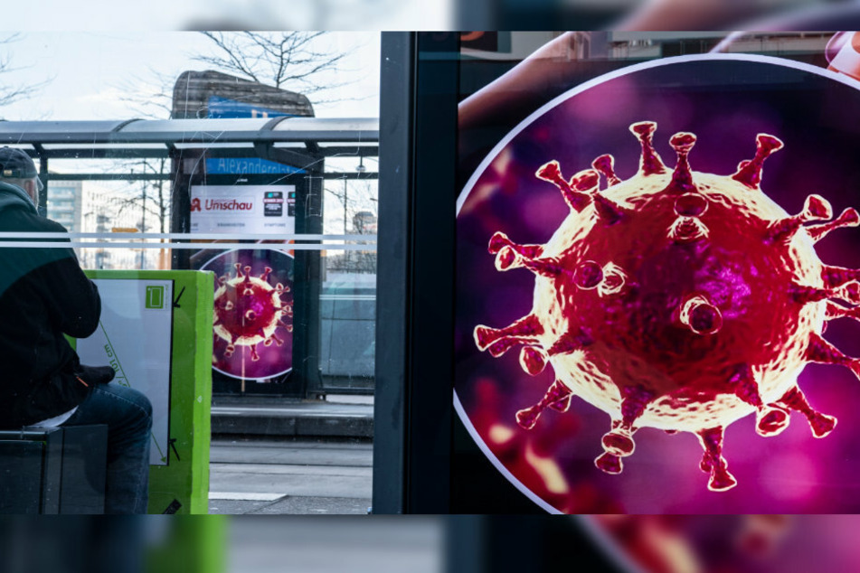 Die Zeichnung eines Coronavirus ist an einer Haltestelle der BVG am Alexanderplatz zu sehen.