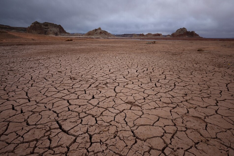 Dry, cracked earth is visible in an area of Lake Powell that was previously underwater in Page, Arizona.
