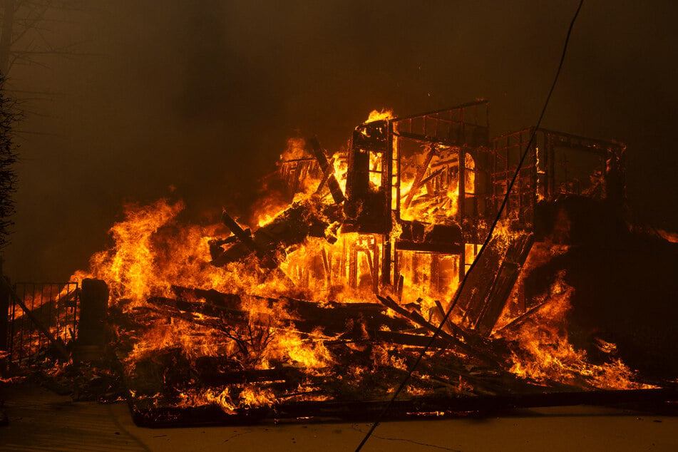 The high winds were complicating firefighting efforts, making it impossible for airplanes to take to the sky, the fire department said.