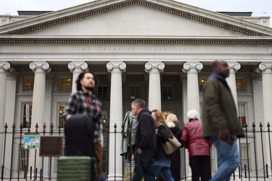 Members of the general public walk past the Treasury Department on April 10, 2025, in Washington, DC.