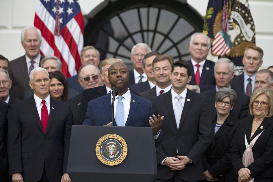 Senator Tim Scott (c.) speaks on the South Lawn of the White House surrounded by his fellow Republicans on December 20th, 2017.