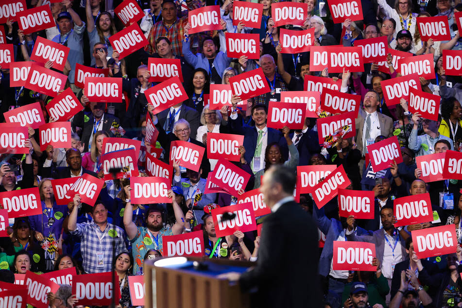 Democratic National Convention attendees raise "Doug" signs during the second gentleman's speech in Chicago, Illinois.