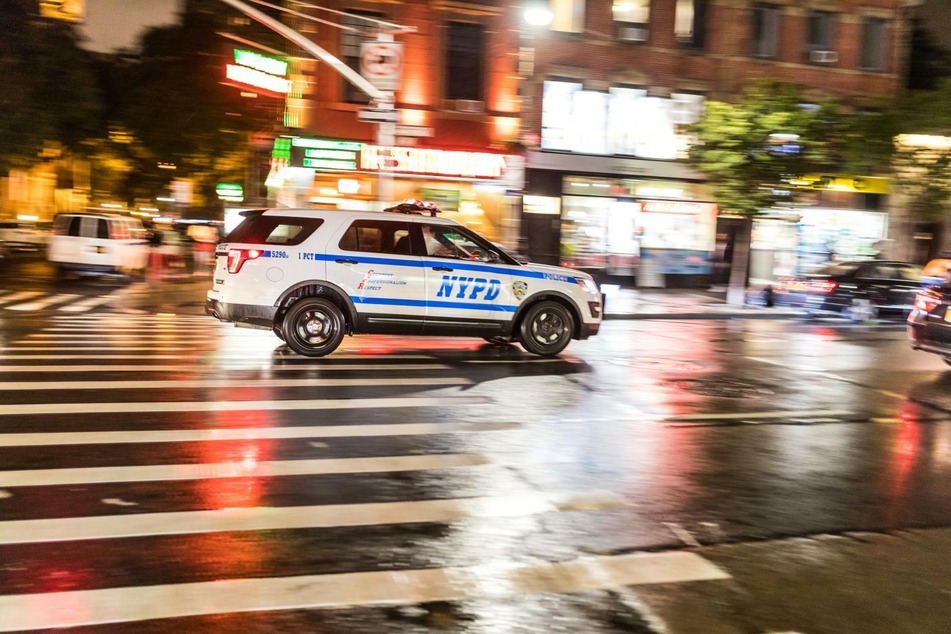 NYPD patrol car racing down the street (stock image).