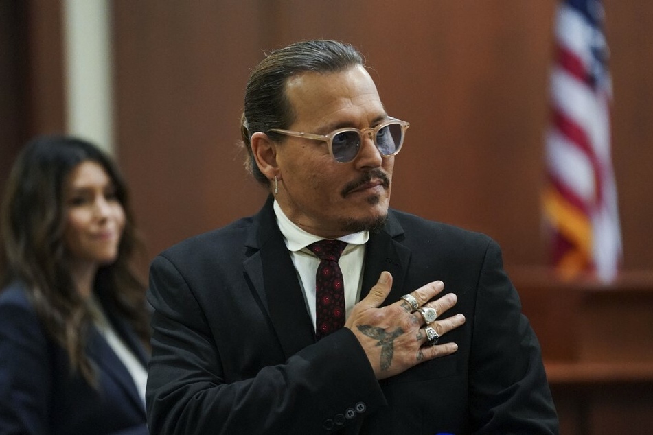 Johnny Depp's lawyer (back l.) has gained praise from fans on social media for her intense questioning during her cross-examination of Amber Heard.