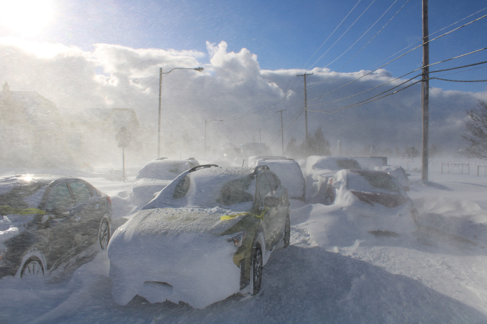 Cars in Buffalo have been submerged in snow as a driving ban remains in effect.