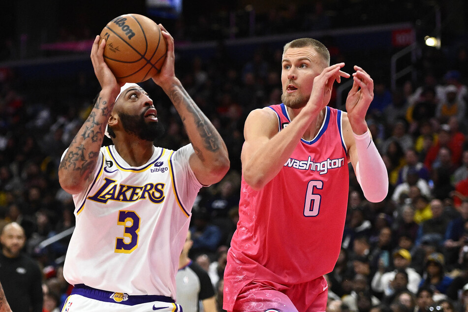 Los Angeles Lakers forward Anthony Davis shoots as Washington Wizards center Kristaps Porzingis defends during the second half at Capital One Arena.