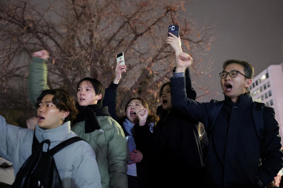 Protesters shout slogans in front of the gate of the National Assembly in Seoul, after South Korean President Yoon Suk Yeol declared martial law, on December 4, 2024.