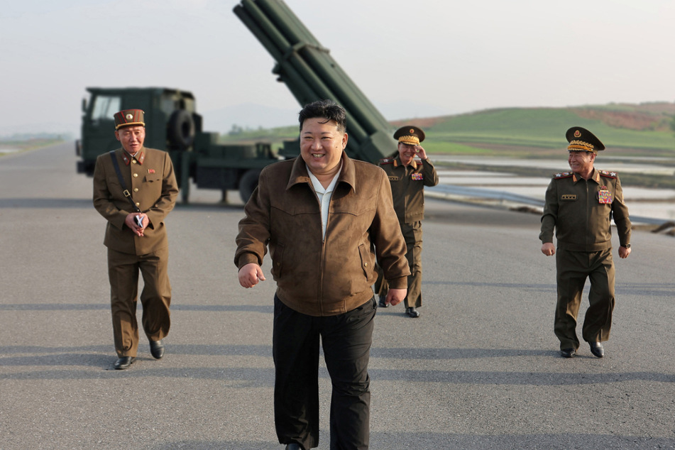 North Korean leader Kim Jong Un inspects the country's artillery weapon system and attends the test-firing of such weapons, at an unknown location, May 10.
