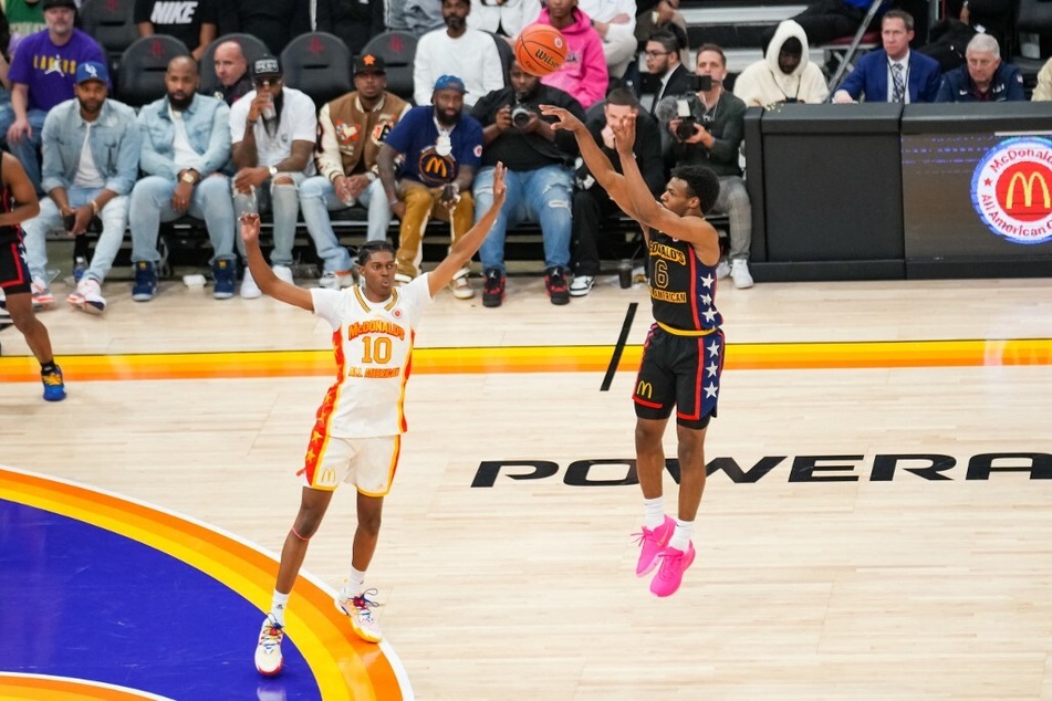 College hoops fans believe Bronny James will commit to USC hoops after sitting near USC athletic representatives during Monday's Lakers game.