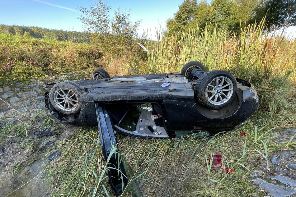 Der BMW blieb in einem Wasserdurchlauf auf dem Dach liegen.