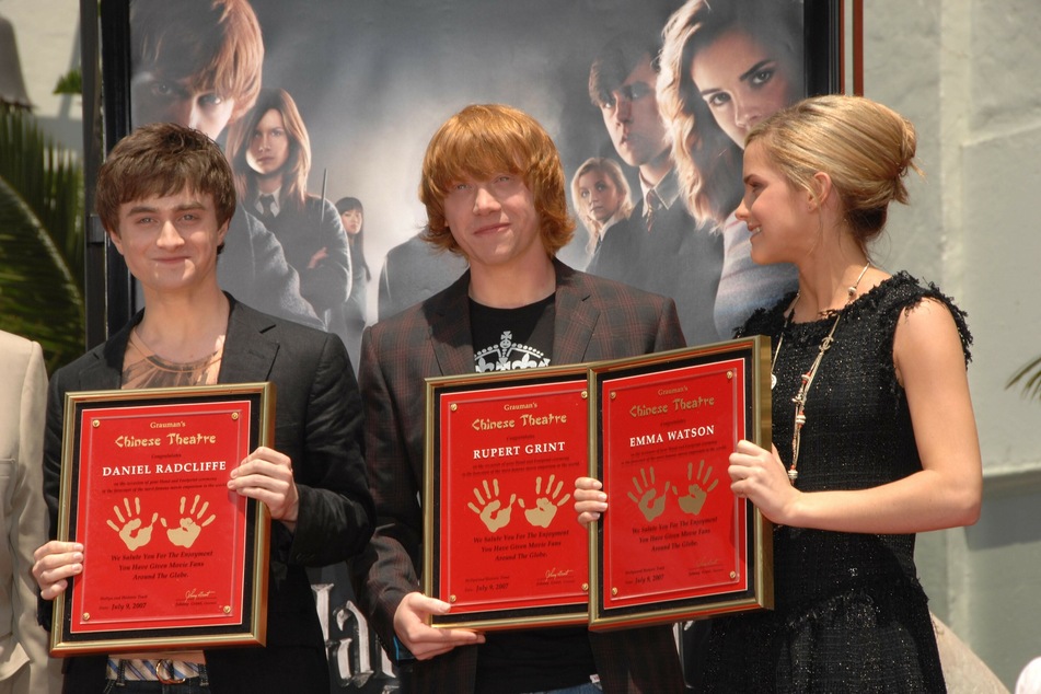 Daniel Radcliffe (l.), Rupert Grint (c.), and Emma Watson at an induction ceremony organized by Grauman's Chinese Theatre in LA.