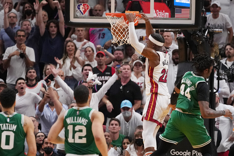Jimmy Butler (2nd from r.) dunks the ball during the Heat's win over the Celtics.