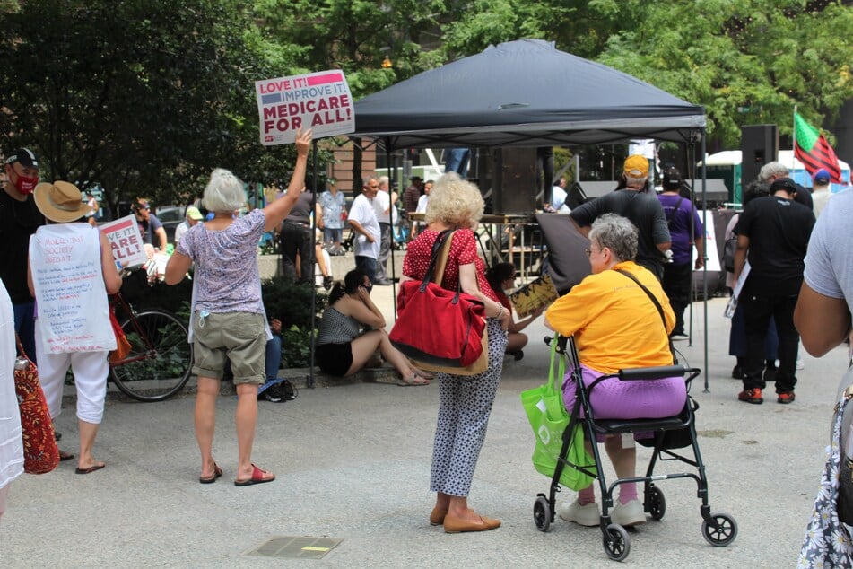 People hold signs in support of Medicare for All at Federal Plaza in Chicago, Illinois, on July 24, 2021.