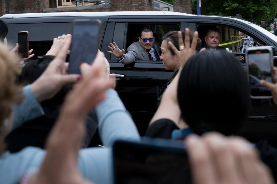 Depp's fans greet him outside the courthouse in Virginia.