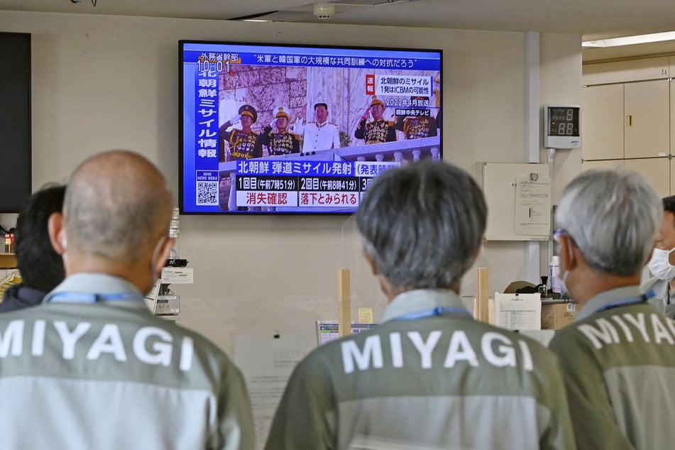 Miyagi Prefectural government officials watch a TV news report about North Korea's firing of ballistic missiles at their office in Sendai, Miyagi Prefecture, Japan.