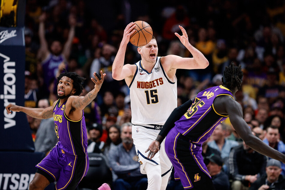 Denver Nuggets center Nikola Jokic grabs a rebound against Los Angeles Lakers forward Sterling Brown and forward Wenyen Gabriel in the third quarter at Ball Arena.