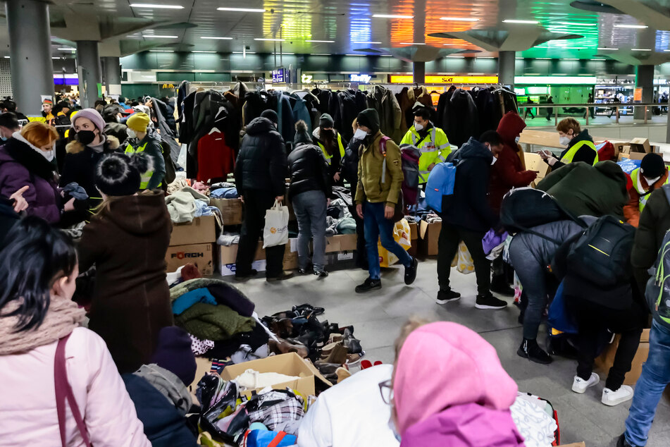 Helfer versorgen ukrainische Flüchtlinge am Berliner Hauptbahnhof mit Kleidung.