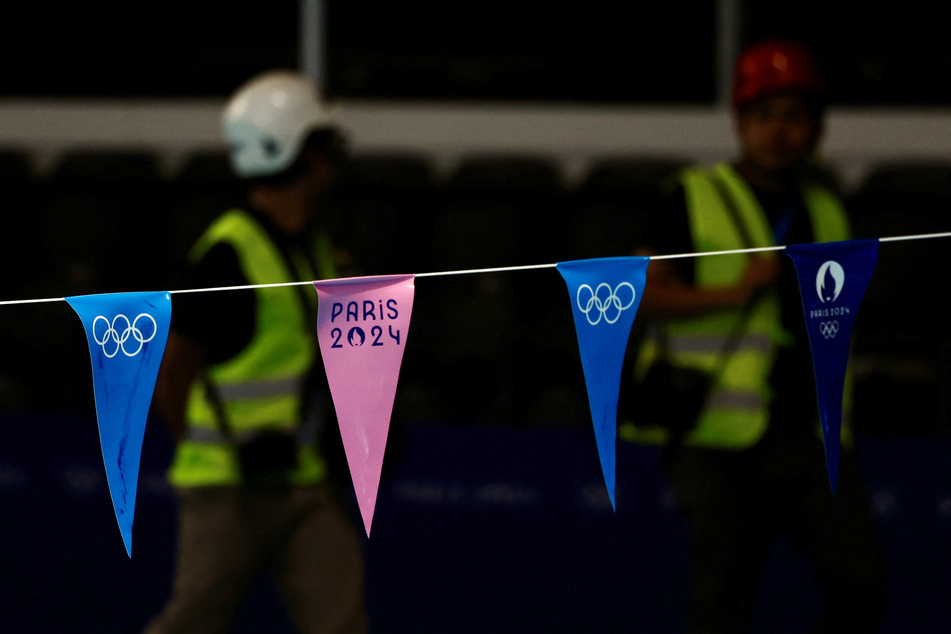 People work to prepare the swimming venue at La Defense ahead of the Paris 2024 Olympics and Paralympics Games.