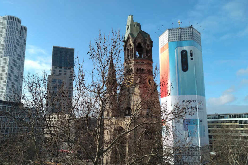 Der Glockenturm an der Berliner Gedächtniskirche wird in den kommenden sechs Monaten von einem Werbebanner verhüllt.