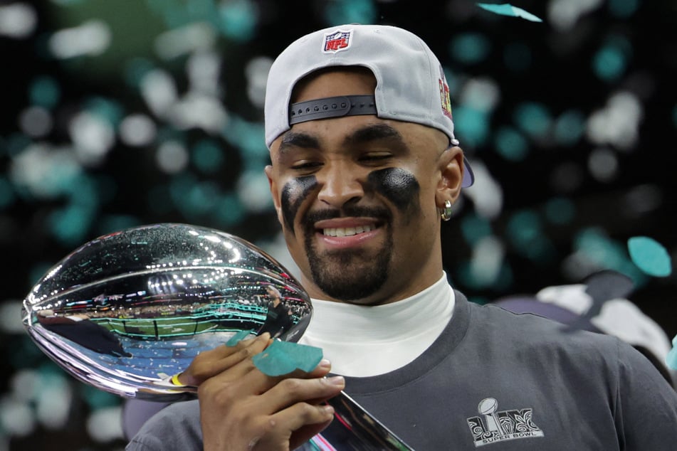 The Philadelphia Eagles' Jalen Hurts holds the Vince Lombardi Trophy after winning Super Bowl LIX.