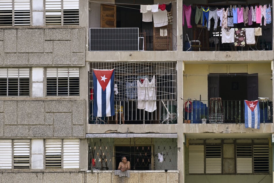 Solar panels and Cuban flags are pictured on the facade of a multi-family building in Viñales, Cuba, on July 26, 2026.