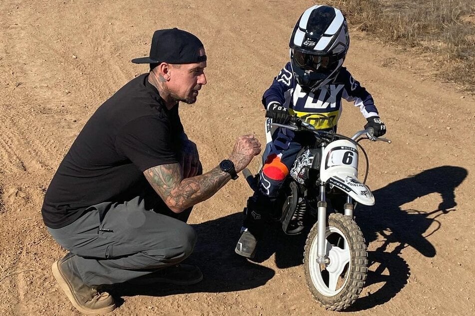 Carey Hart (45) shows his son Jameson (3) how to ride the motorbike.