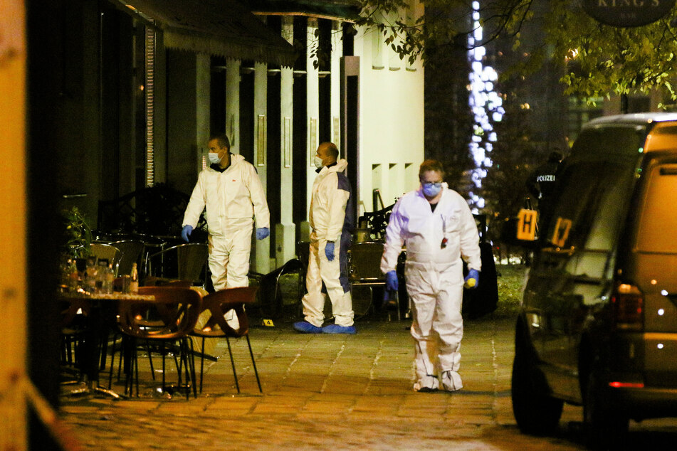 Investigators secure the crime scene after multiple people were shot in a terrorist attack.