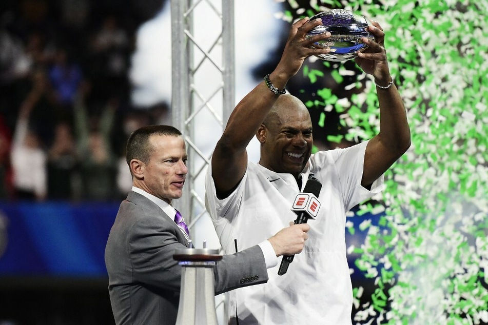 Head coach Mel Tucker of the Michigan State Spartans holds the championship trophy after defeating the Pittsburgh Panthers during the Chick-Fil-A Peach Bowl.