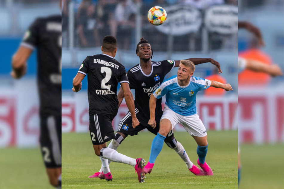 Gideon Jung (Mitte) kämpft im DFB-Pokal gegen den Chemnitzer Philipp Sturm um den Ball.
