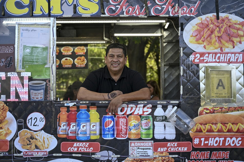 William Arevalo poses for a picture in his electric battery powered food cart in New York City's Flushing Meadows-Corona Park on July 23, 2026.