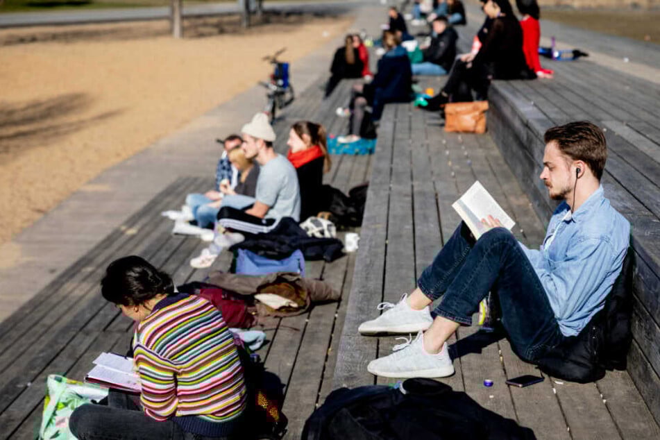 Berliner genießen am Park Gleisdreieck die Sonne.