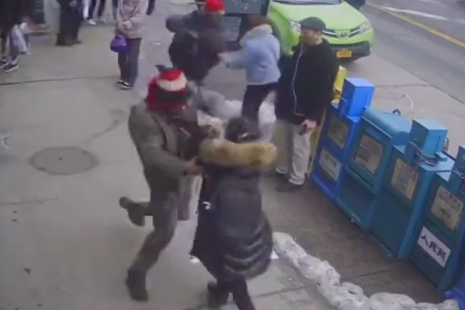 Security footage shows the suspect attacking the Asian-American woman in Flushing, Queens.