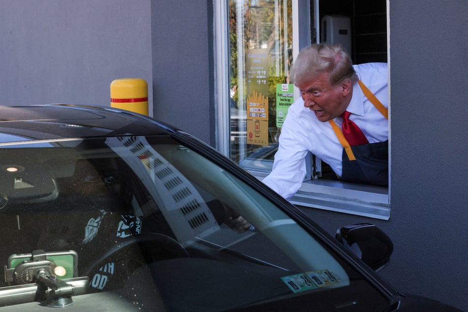 Republican presidential nominee Donald Trump serves food at a McDonald's restaurant in Feasterville-Trevose, Pennsylvania, on October 20, 2024.