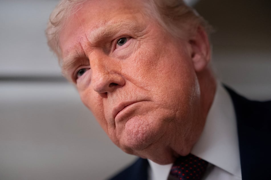 President Donald Trump speaks with members of the media aboard Air Force One en route from Florida to Joint Base Andrews, Maryland, on January 11, 2026.