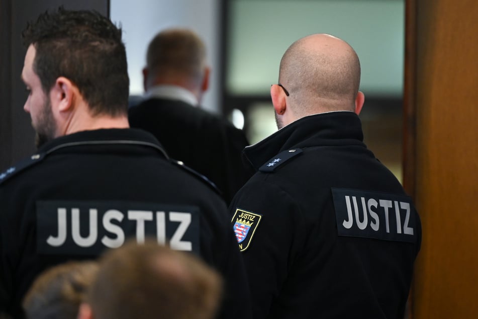 Justizbeamte warten zu Beginn eines Sicherungsverfahrens gegen eine Frau wegen eines Giftanschlags auf Angehörige der Technischen Universität (TU) Darmstadt im Gerichtssaal des Landgerichts auf die Angeklagte.