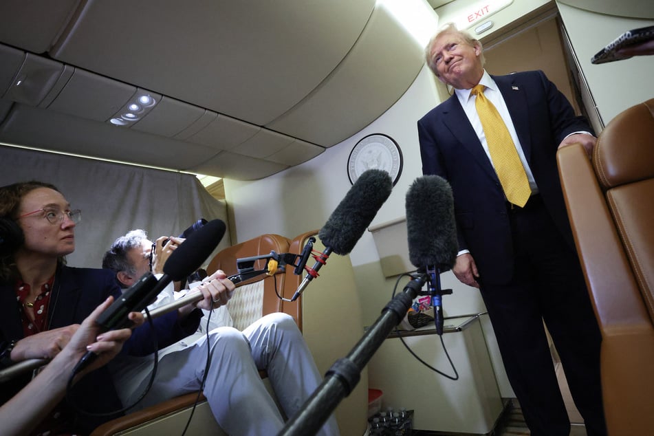 President Donald Trump speaks to members of the press while in flight to Joint Base Andrews on July 8, 2026.