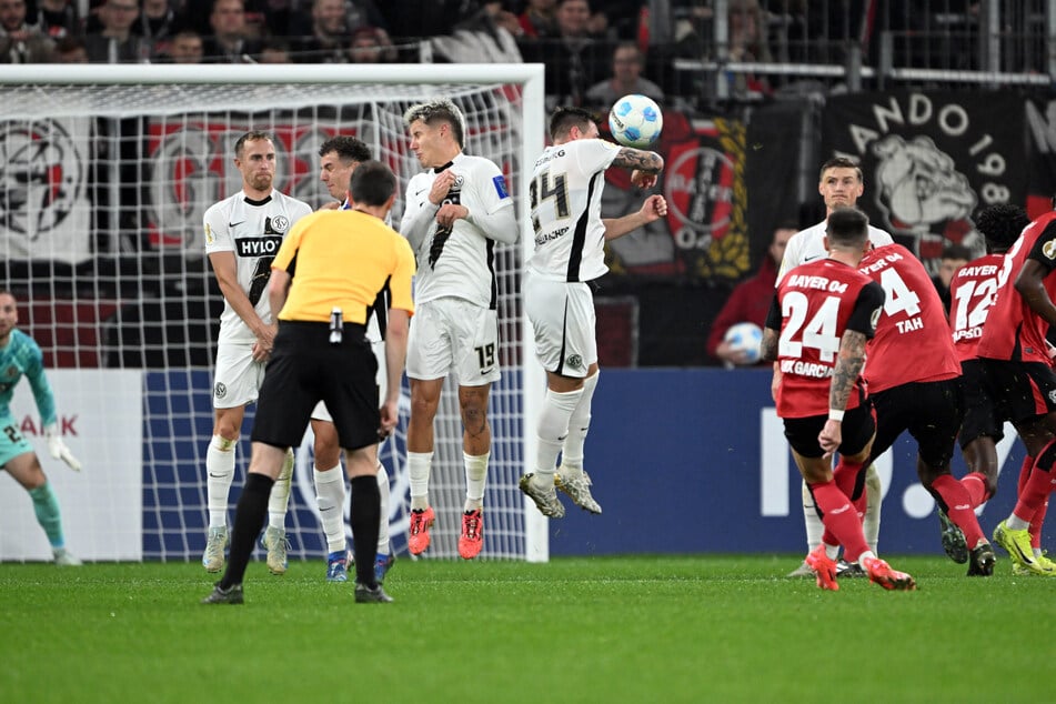 Was für ein geiles Tor! Ein präzise über die Mauer gezwirbelter Freistoß von Leverkusens Aleix Garcia landet in den Maschen des Elverseberger Kastens.