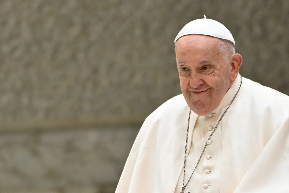 One of the doctors treating Pope Francis said on Friday the 88-year-old, who has pneumonia, was "not out of danger" and would likely stay in the hospital "at least all next week."