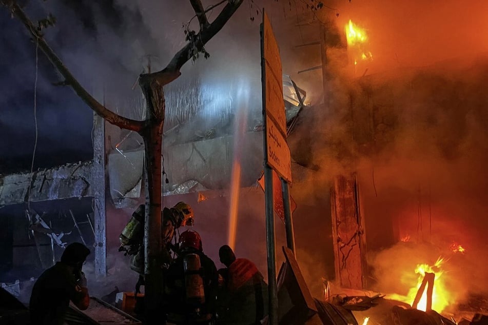 Lebanese firefighters douse the flames at the site of an Israeli strike that targeted a building in Beirut’s Mar Elias street on November 17, 2024.