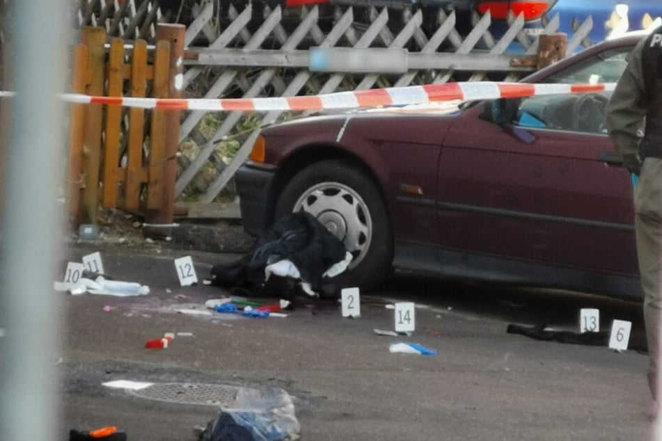 Markierungen der Polizei liegen nach einer Messerstecherei neben einem Auto auf der Strasse. Ein Mann hat ein Ehepaar mit einem Messer angegriffen.