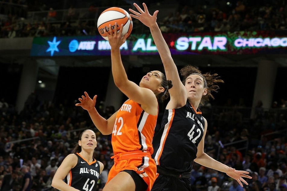 Kelsey Plum (l) drives to the basket against Breanna Stewart (r) during the 2022 AT&amp;T WNBA All-Star Game.