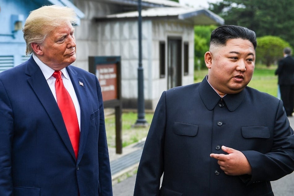 North Korea's leader Kim Jong-un (r.) stands with US President Donald Trump south of the Military Demarcation Line that divides North and South Korea on June 30, 2019.