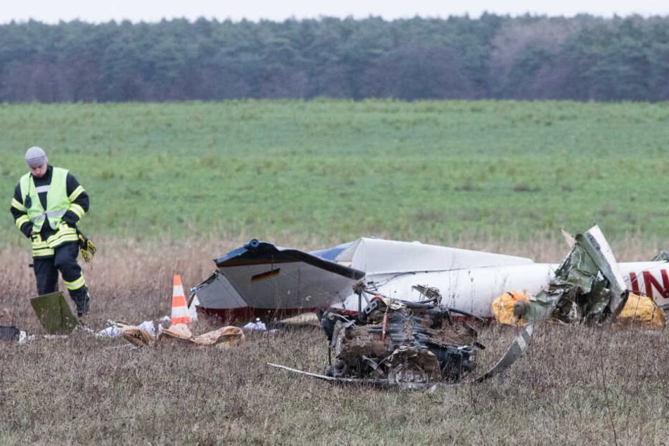 Die Trümmer eines Flugzeugs liegen nach einem Absturz auf einem Feld.