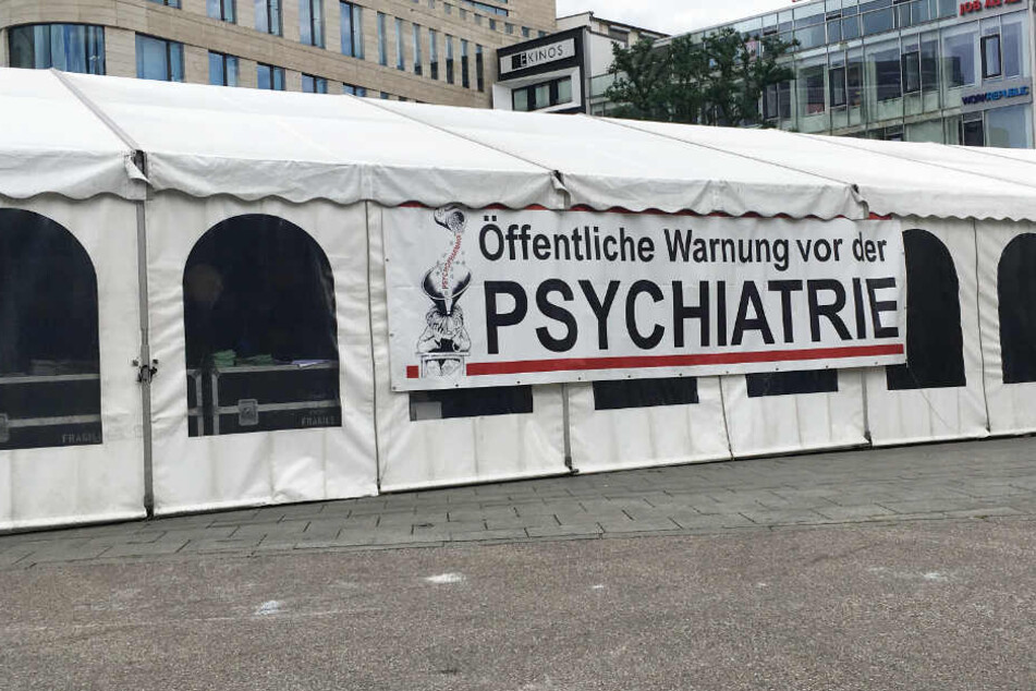 "Öffentliche Warnung vor der Psychiatrie" steht auf dem Plakat, das an der Querseite des Zeltes hängt.