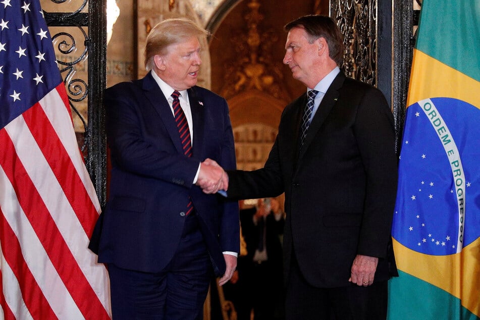 US President Donald Trump shakes hands with Brazilian President Jair Bolsonaro before attending a working dinner at the Mar-a-Lago resort in Palm Beach, Florida, on March 7, 2020.