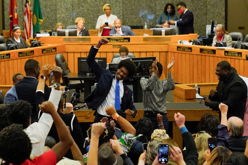 Justin Pearson pumps his fist after securing his return to the Tennessee State Capitol.