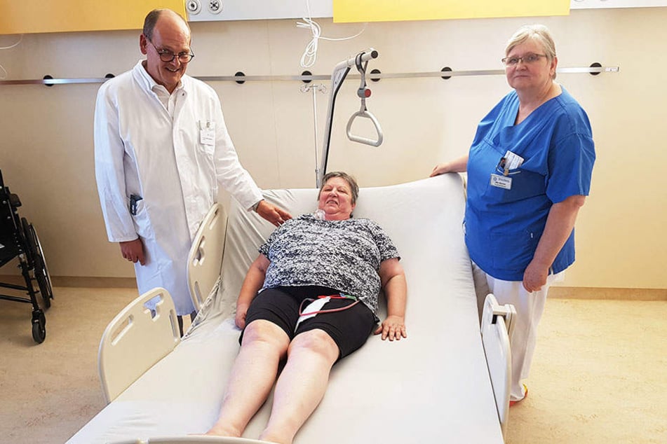 Patientin Kerstin Storch (63) aus Chemnitz konnte die neuen Schwerlastbetten bereits testen, flankiert von Chefarzt Lippmann (55) und einer Pflegerin.