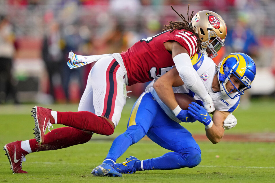 San Francisco 49ers linebacker Fred Warner (l.) tackles Los Angeles Rams wide receiver Cooper Kupp during the second quarter at Levi's Stadium on Monday night.