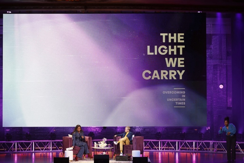 Michelle Obama and Ellen DeGeneres speak onstage during the Michelle Obama: The Light We Carry Tour at Warner Theatre.
