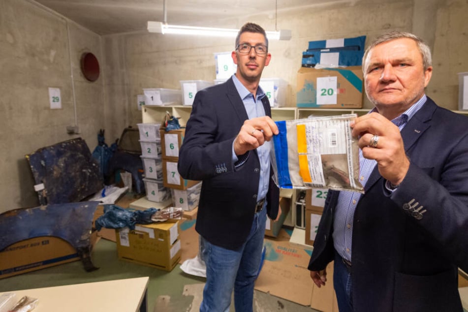 Thilo Speich (links), stellvertretender Leiter der Ermittlungsgruppe Göhrde bei der Polizeidirektion Lüneburg, und Jürgen Schubbert, Leiter der Ermittlungsgruppe Göhrde, zeigen in der Asservatenkammer Teile eines Revolvers.